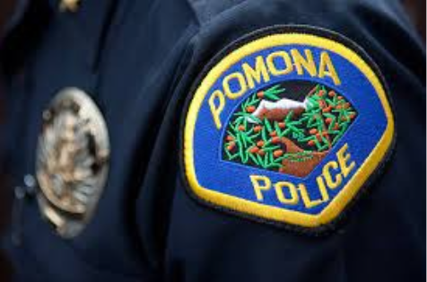 Pomona Police badge on an officer's shoulder